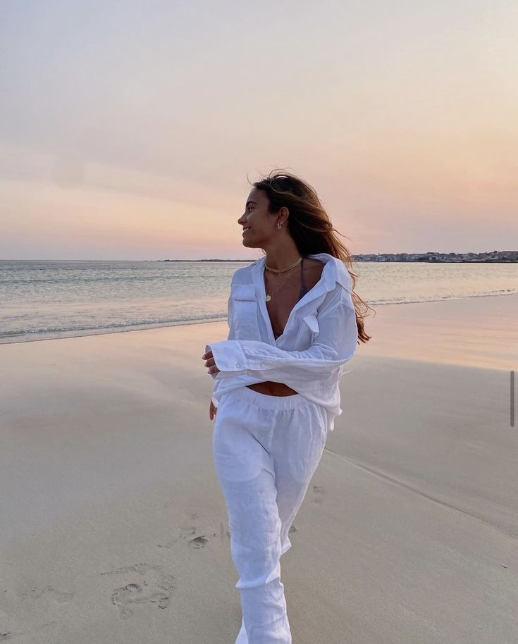 a woman in white on a beach